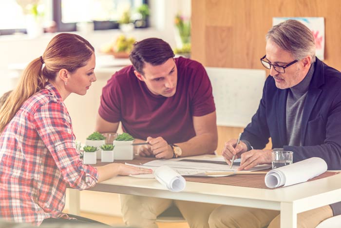 clients reviewing new home blueprints